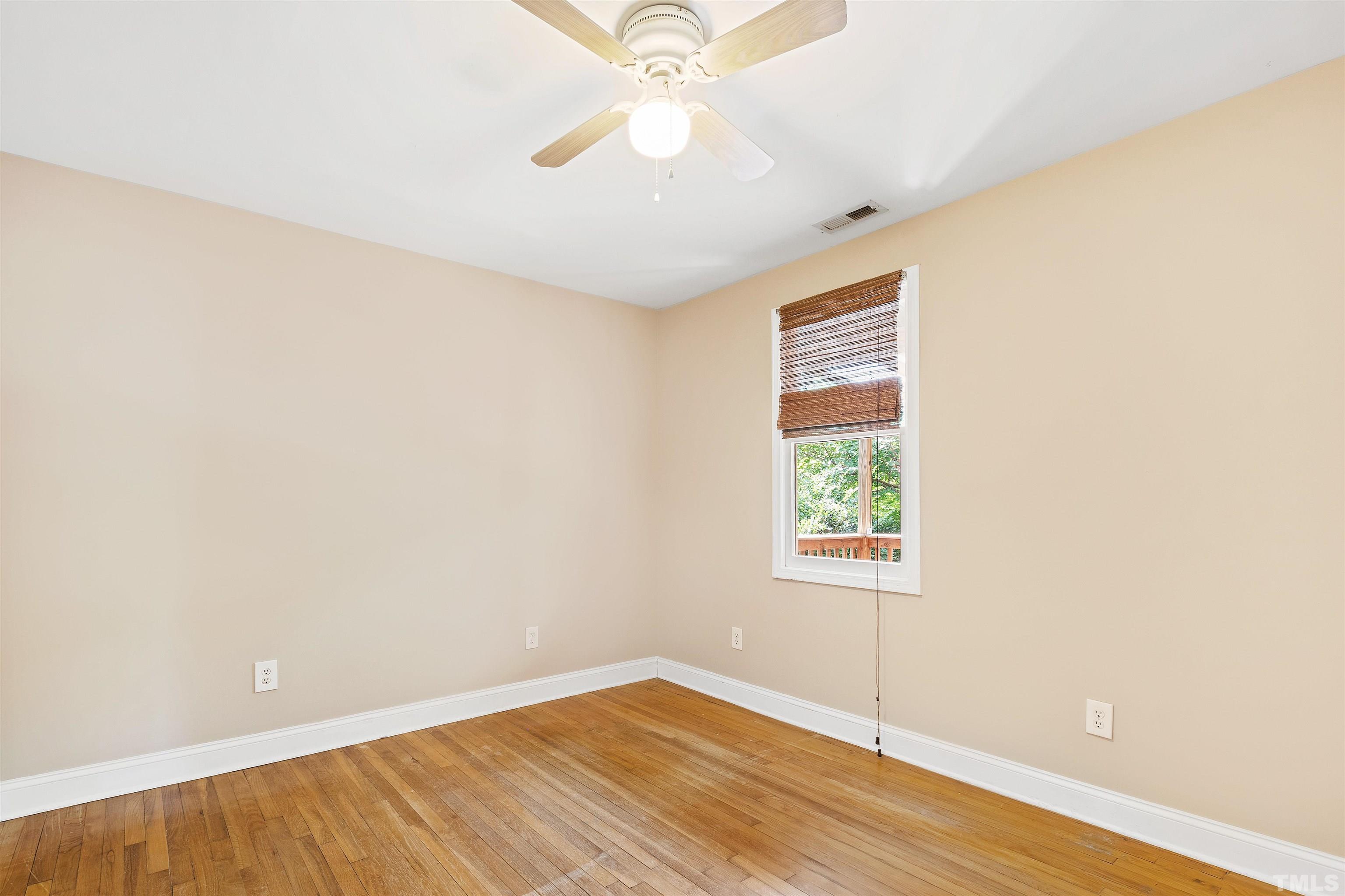 1013 Brookside Drive Raleigh, NC 27604 - Photo 16 of 40 an empty room with a window and a ceiling fan