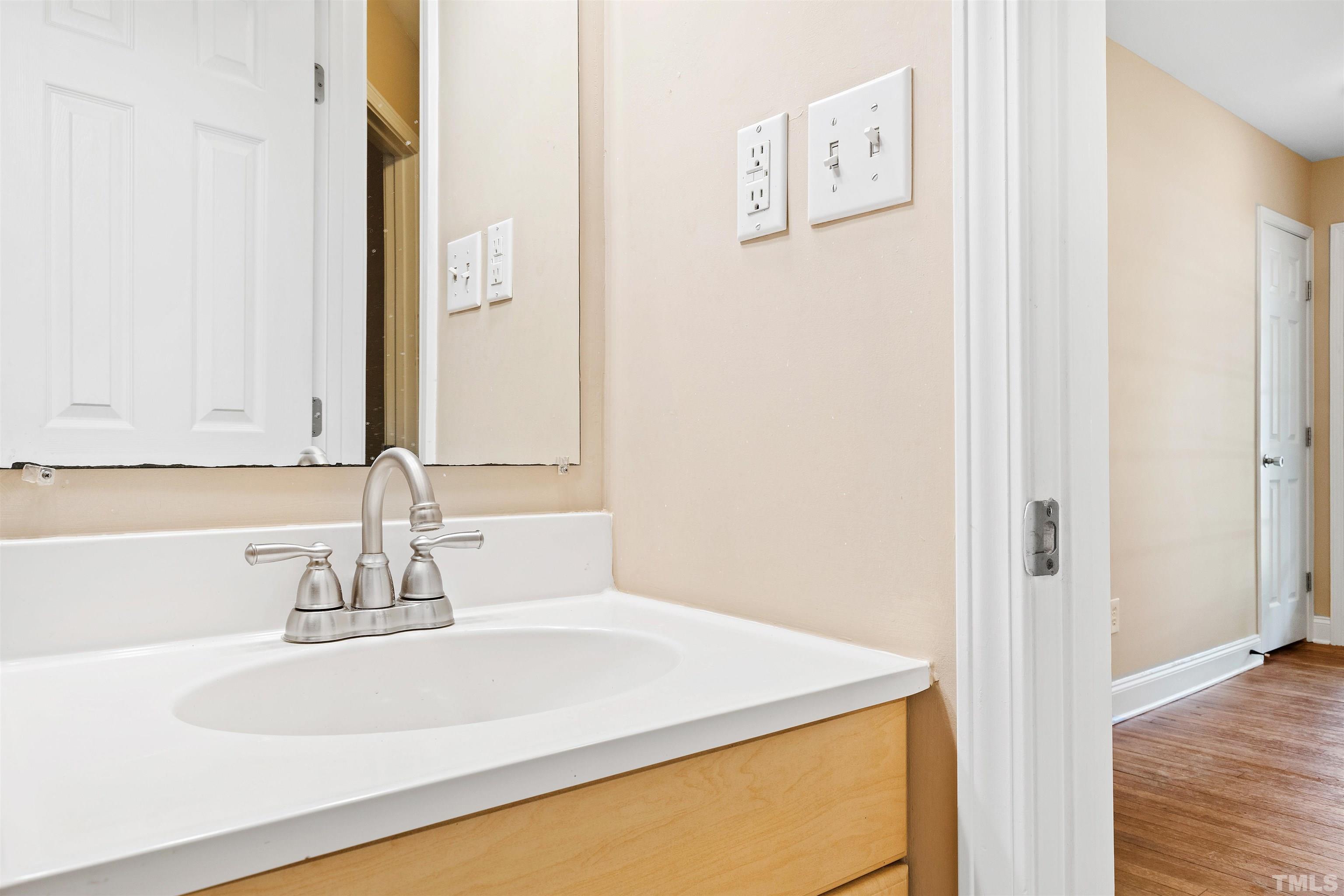 1013 Brookside Drive Raleigh, NC 27604 - Photo 18 of 40 a bathroom with a sink and a mirror