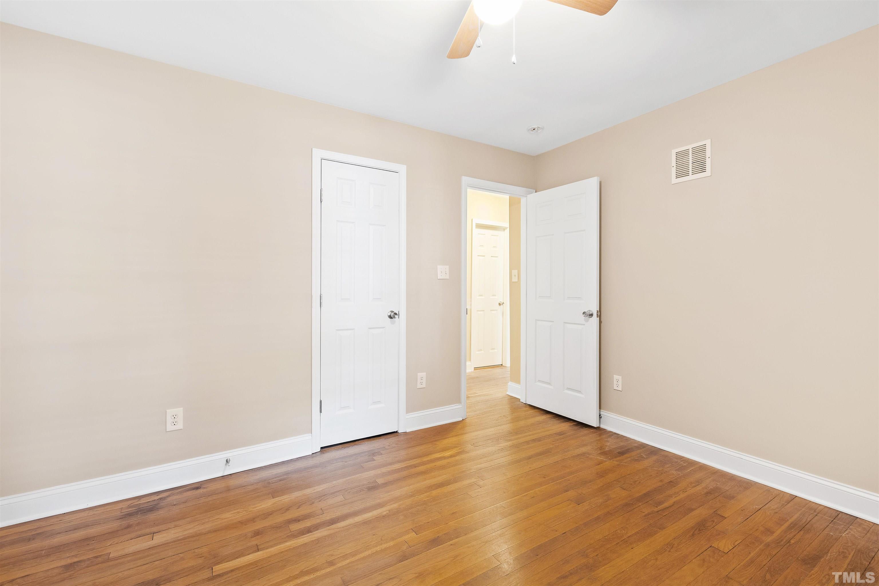 1013 Brookside Drive Raleigh, NC 27604 - Photo 22 of 40 a view of an empty room with wooden floor