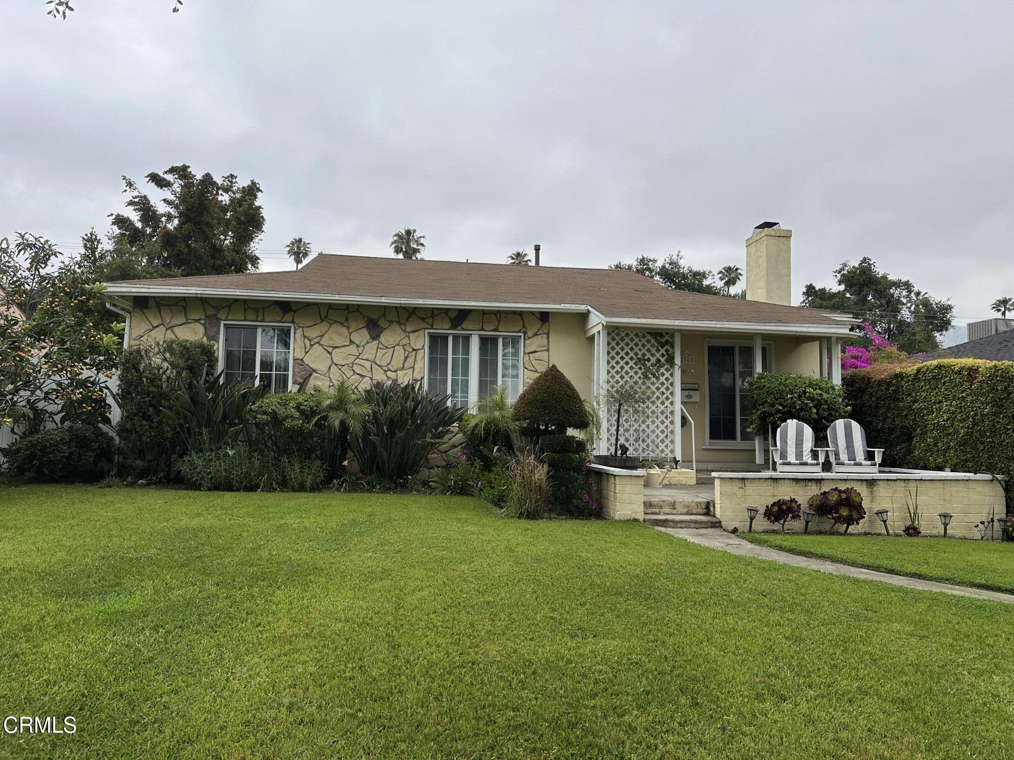 a front view of a house with garden