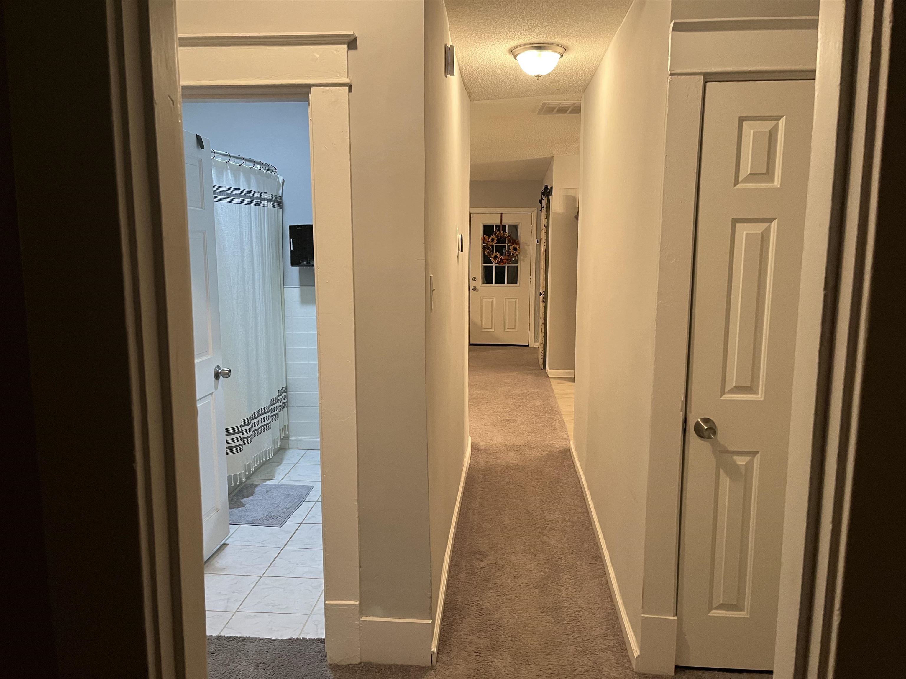 723 Spring Street Memphis, TN 38112 - Photo 18 of 18 a view of a bathroom from a hallway