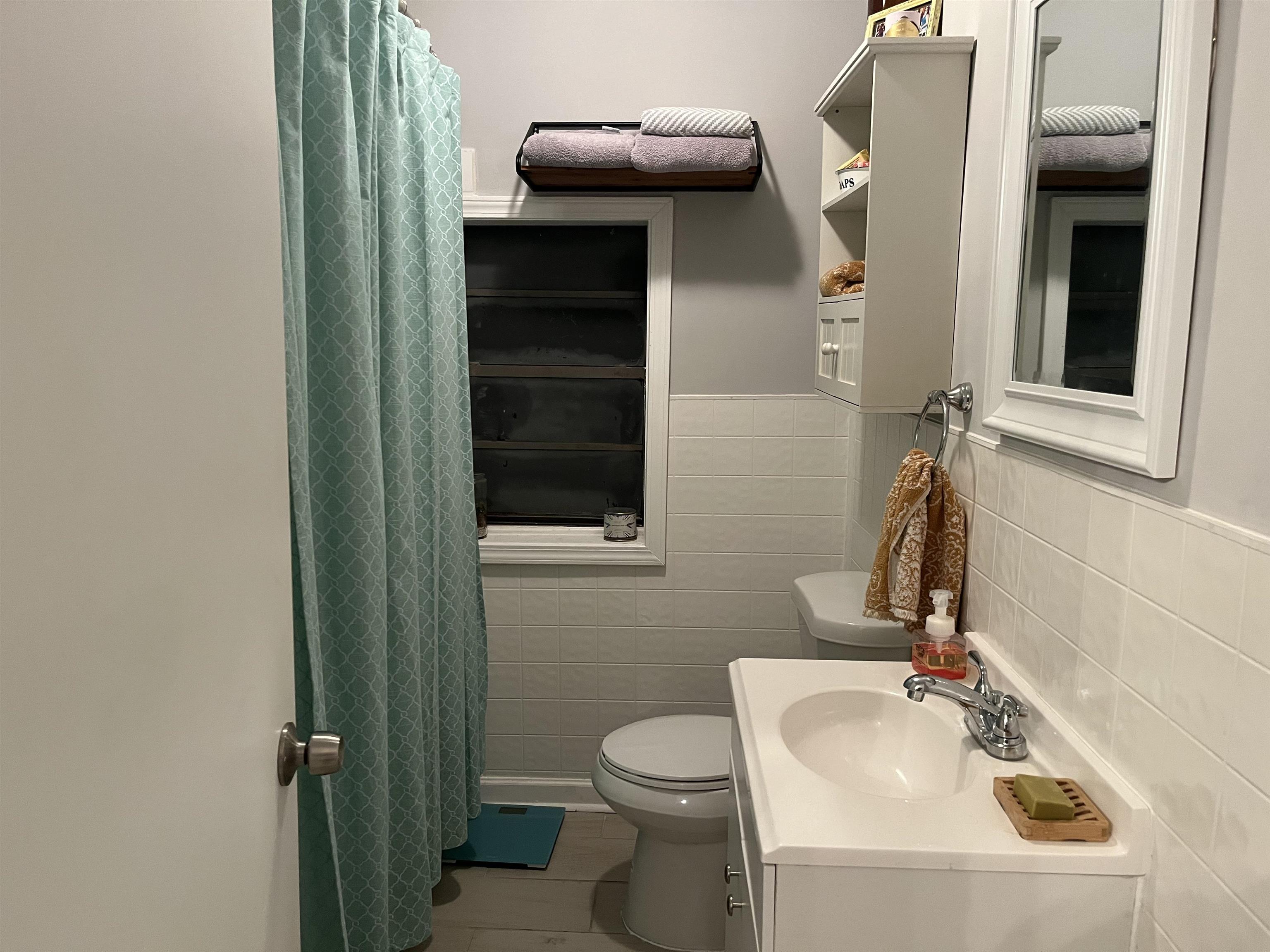 723 Spring Street Memphis, TN 38112 - Photo 7 of 18 a bathroom with a toilet sink and mirror