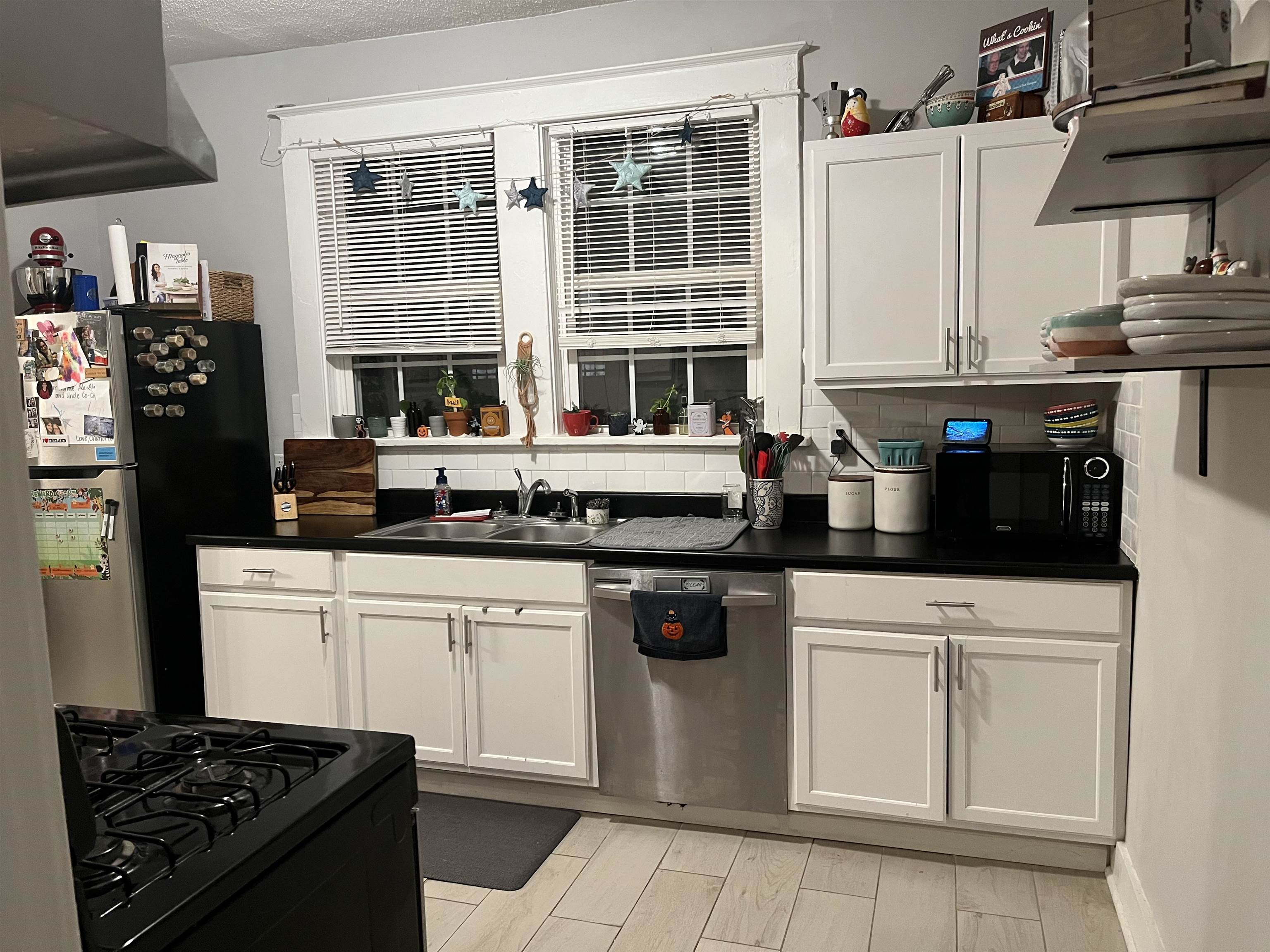723 Spring Street Memphis, TN 38112 - Photo 10 of 18 a kitchen with stainless steel appliances a stove a sink and a refrigerator