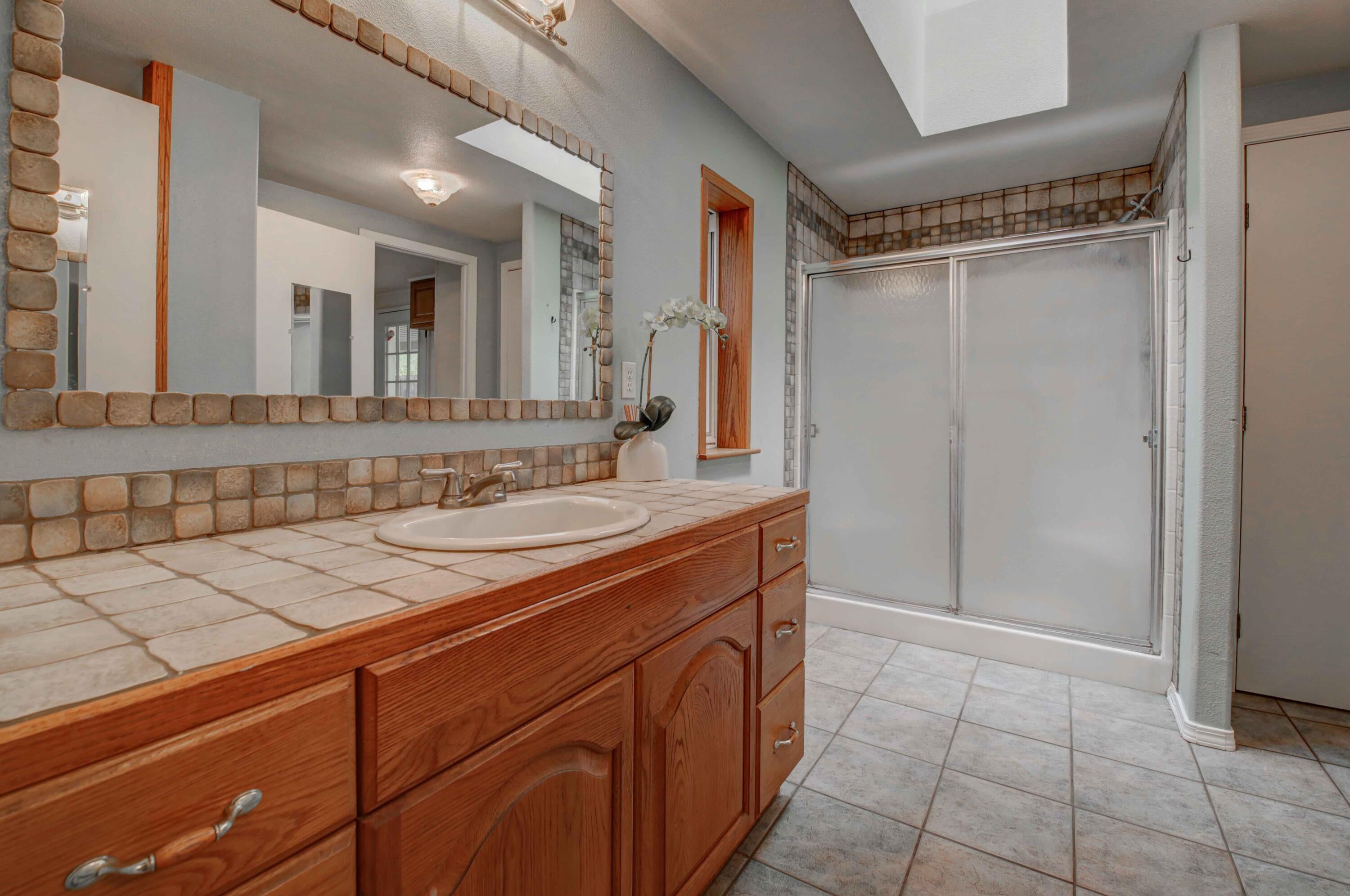 60184 Crater Road Bend, OR 97702 - Photo 13 of 29 Primary suite bathroom with tiled vanity counter and floors.