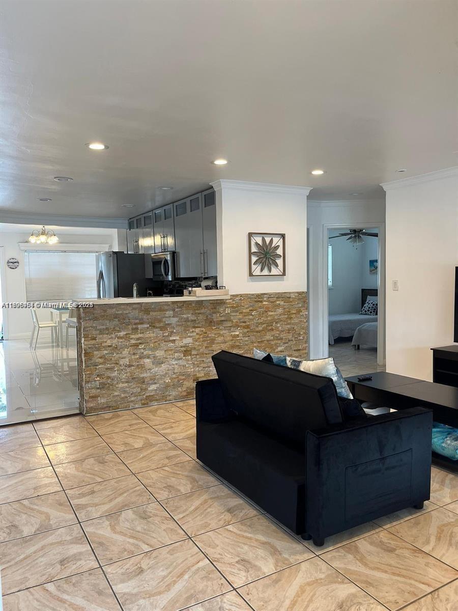 6431 Hayes Street, Unit 2 Hollywood, FL 33024 - Photo 11 of 14 a living room with couches and kitchen view