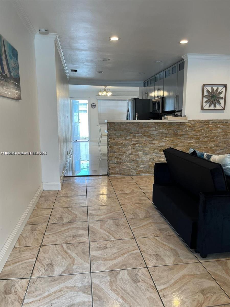 6431 Hayes Street, Unit 2 Hollywood, FL 33024 - Photo 13 of 14 a view of a living room with a rug