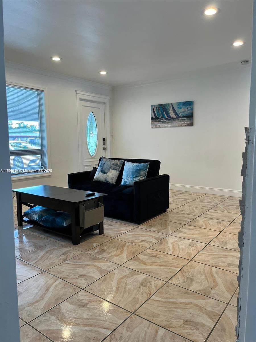 6431 Hayes Street, Unit 2 Hollywood, FL 33024 - Photo 5 of 14 a living room with furniture and a window