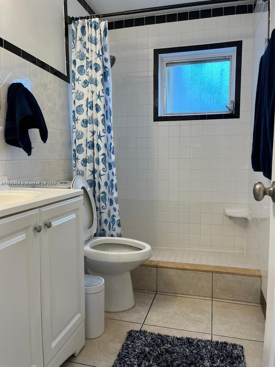 6431 Hayes Street, Unit 2 Hollywood, FL 33024 - Photo 6 of 14 a bathroom with a toilet and a shower