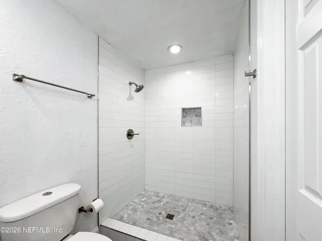 a bathroom with a shower and a toilet