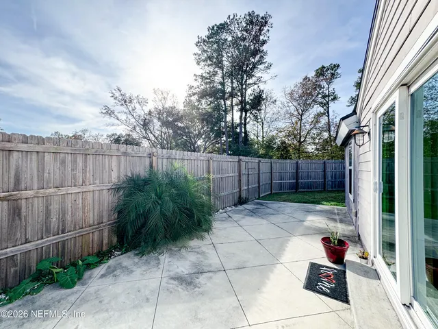 a view of a backyard with plants and entertaining space
