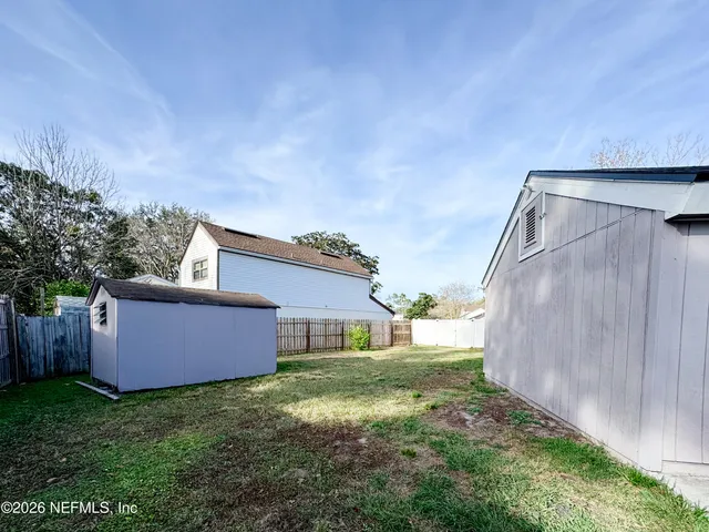 a backyard of a house with lots of green space