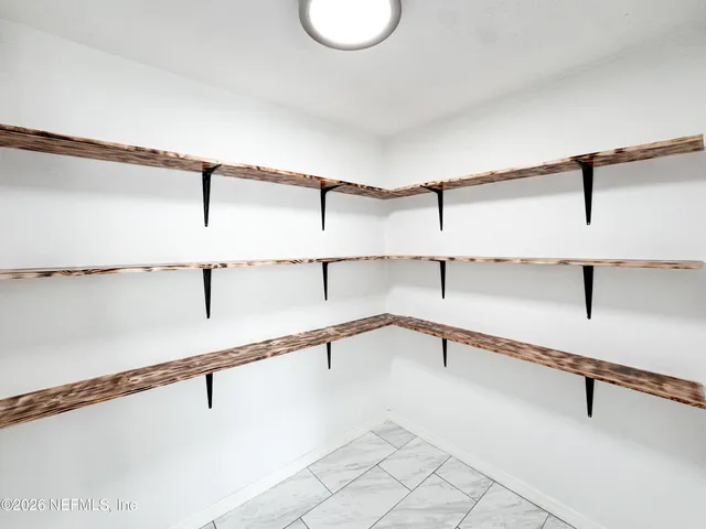 a view of a room with racks on the wall