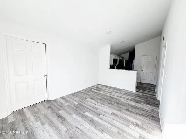 a view of a room with wooden floor