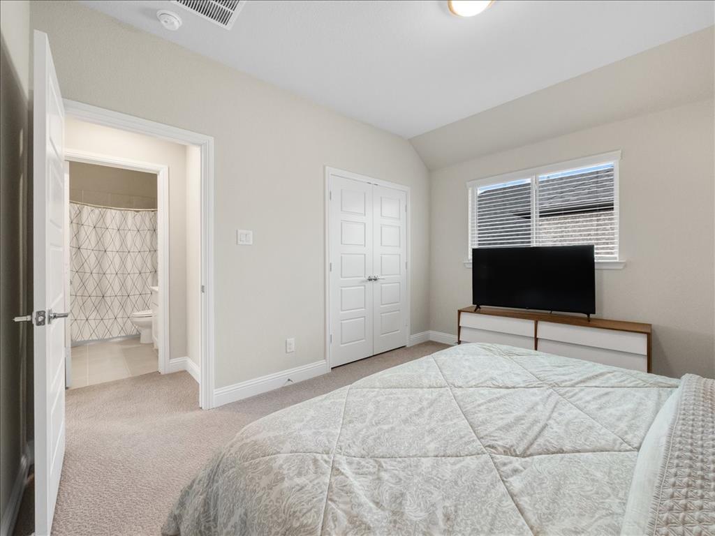 8240 Ottowa Ridge Frisco, TX 75034 - Photo 15 of 25 a bedroom with a bed and a flat screen tv