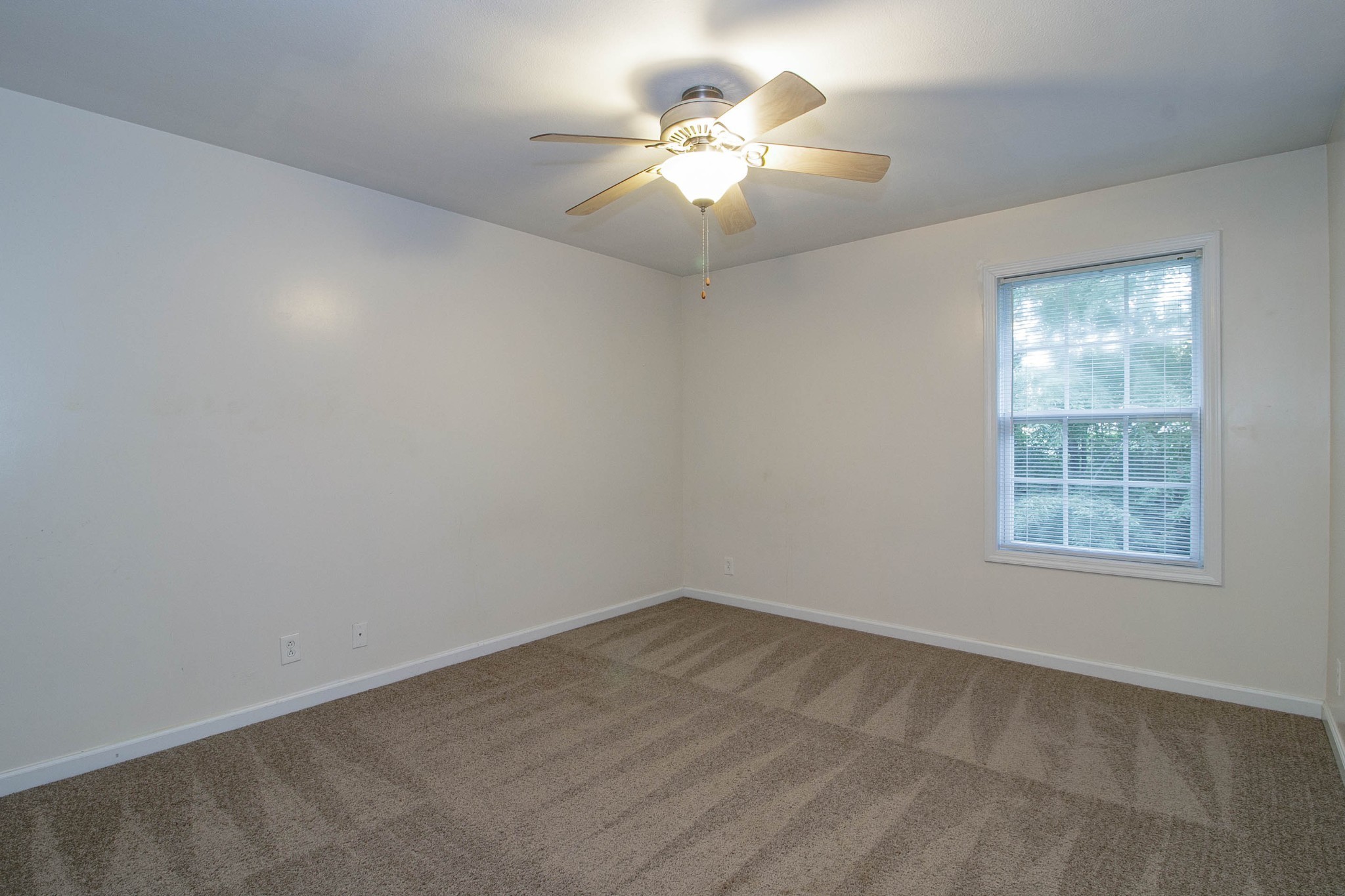 299 Raleigh Drive, Unit F2 Clarksville, TN 37043 - Photo 19 of 27 an empty room with chandelier fan and windows