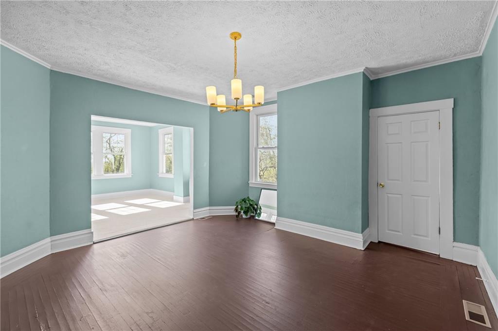 2 Marshall Road Pittsburgh, PA 15214 - Photo 17 of 46 an empty room with wooden floor chandelier and windows