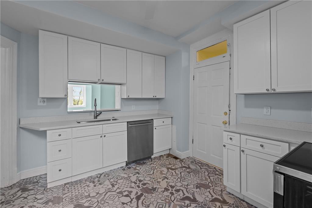 2 Marshall Road Pittsburgh, PA 15214 - Photo 26 of 46 a kitchen with granite countertop white cabinets and stainless steel appliances