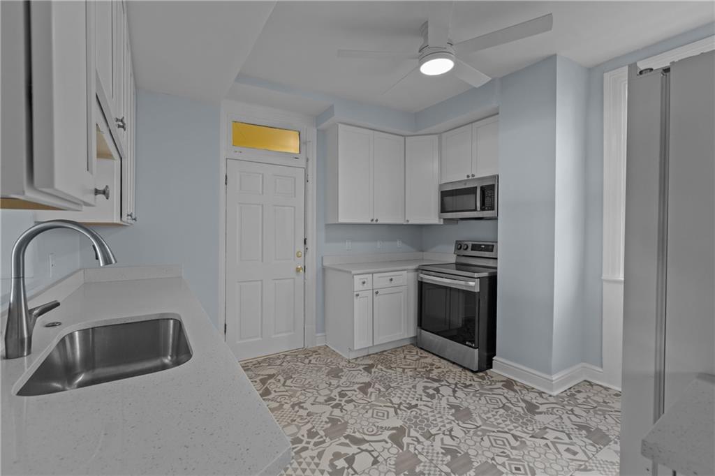 2 Marshall Road Pittsburgh, PA 15214 - Photo 28 of 46 a kitchen with stainless steel appliances granite countertop a sink a stove cabinets and a refrigerator