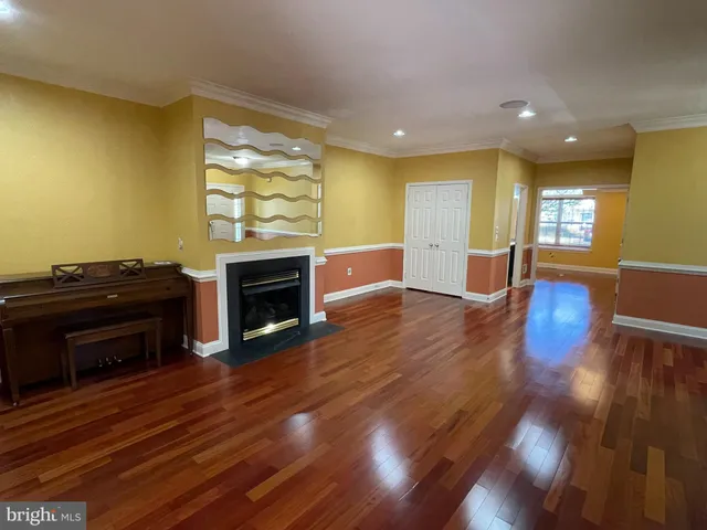 a view of a room with wooden floor windows and stairs