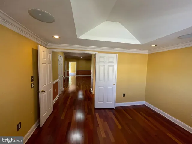a balcony with wooden floor and trees