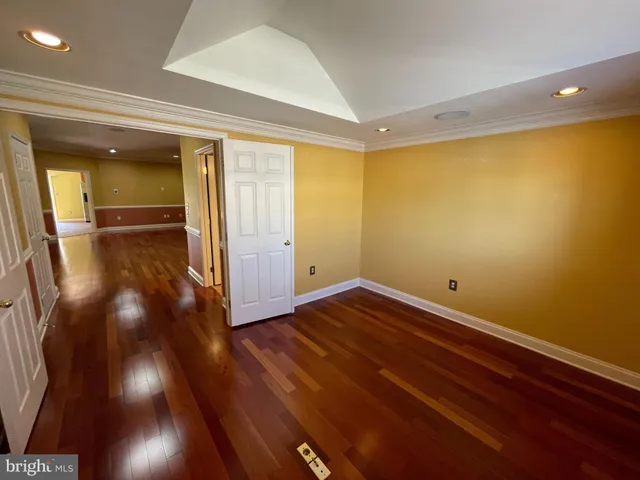 an empty room with windows and ceiling fan