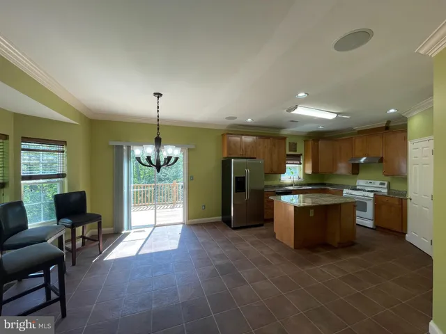 a large kitchen with a table and chairs