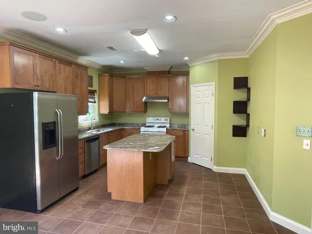 a kitchen with a stove a refrigerator a sink and dishwasher