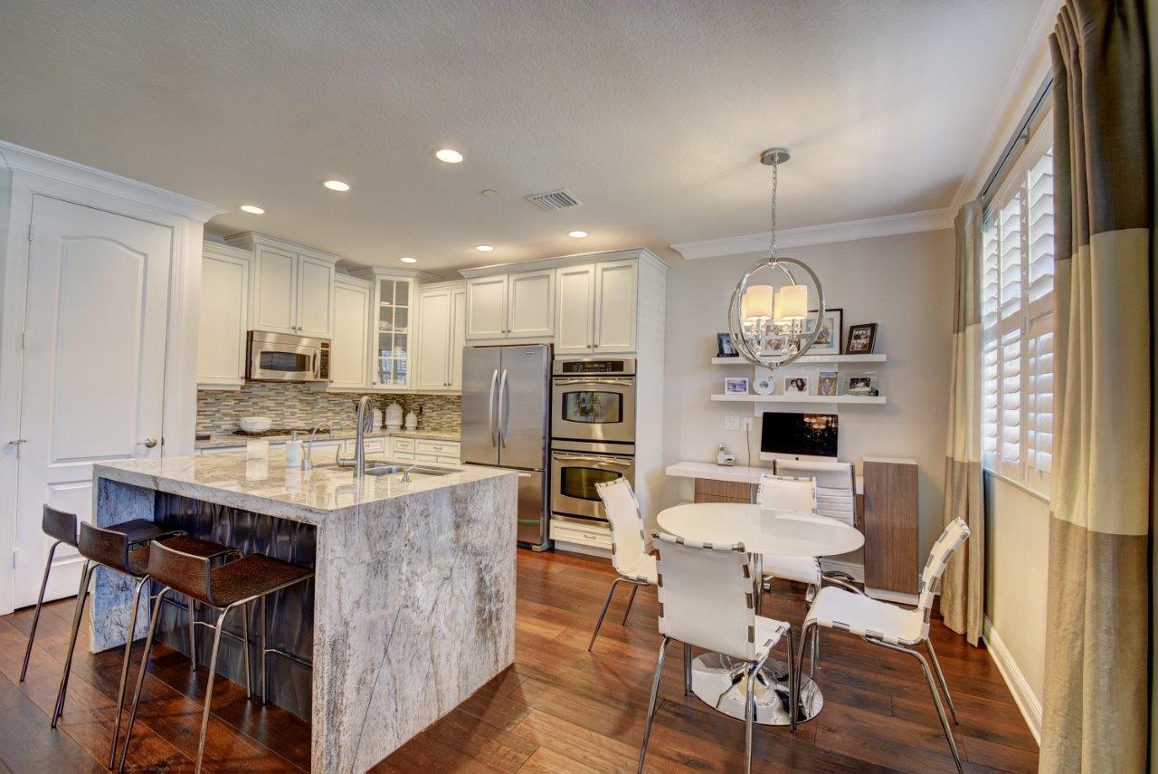 5610 Northeast Trieste Terrace Boca Raton, FL 33487 - Photo 20 of 44 a view of kitchen with kitchen island stainless steel appliances refrigerator stove dining table and chairs