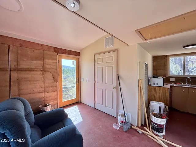 a livingroom with furniture and a flat screen tv