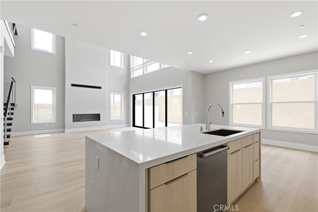 156 Apron Irvine, CA 92618 - Photo 7 of 40 a kitchen with granite countertop a stove and a sink