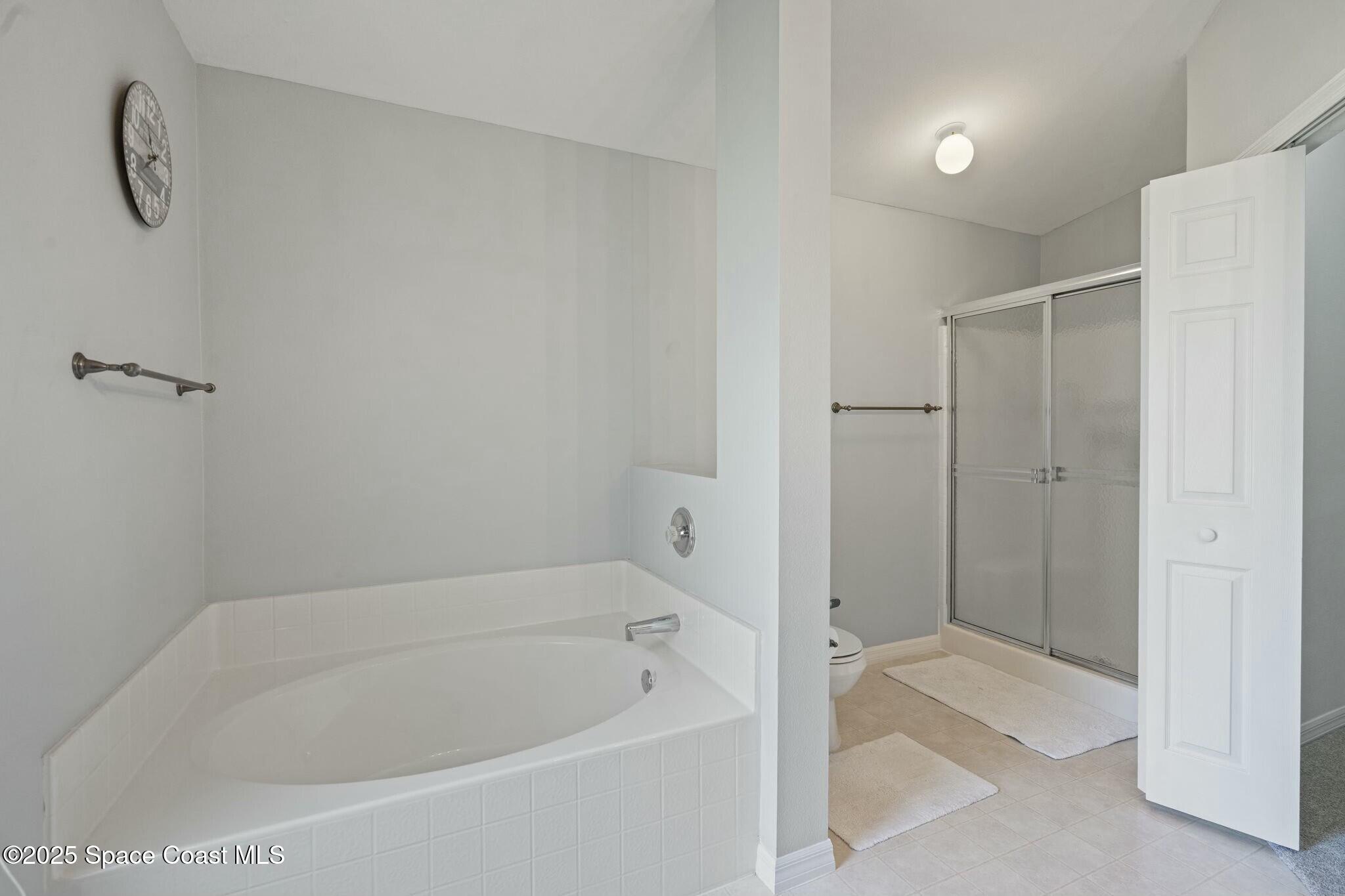 2405 Bayhill Drive Melbourne, FL 32940 - Photo 13 of 36 a bathroom with a bathtub and a shower