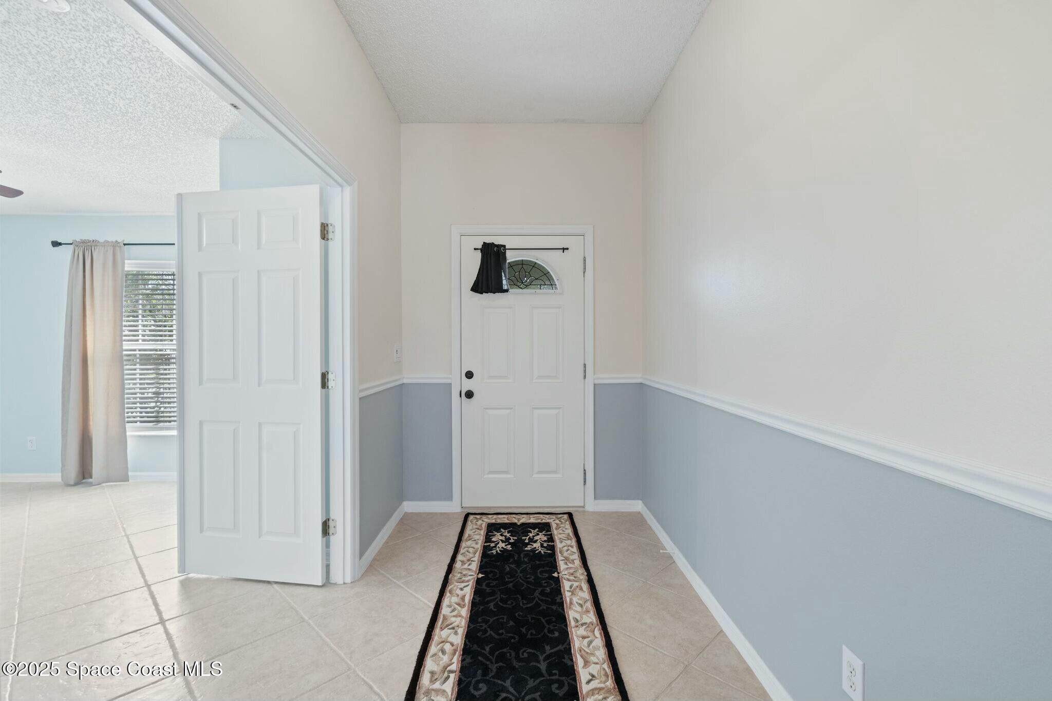2405 Bayhill Drive Melbourne, FL 32940 - Photo 17 of 36 a view of a closet area with hardwood floor