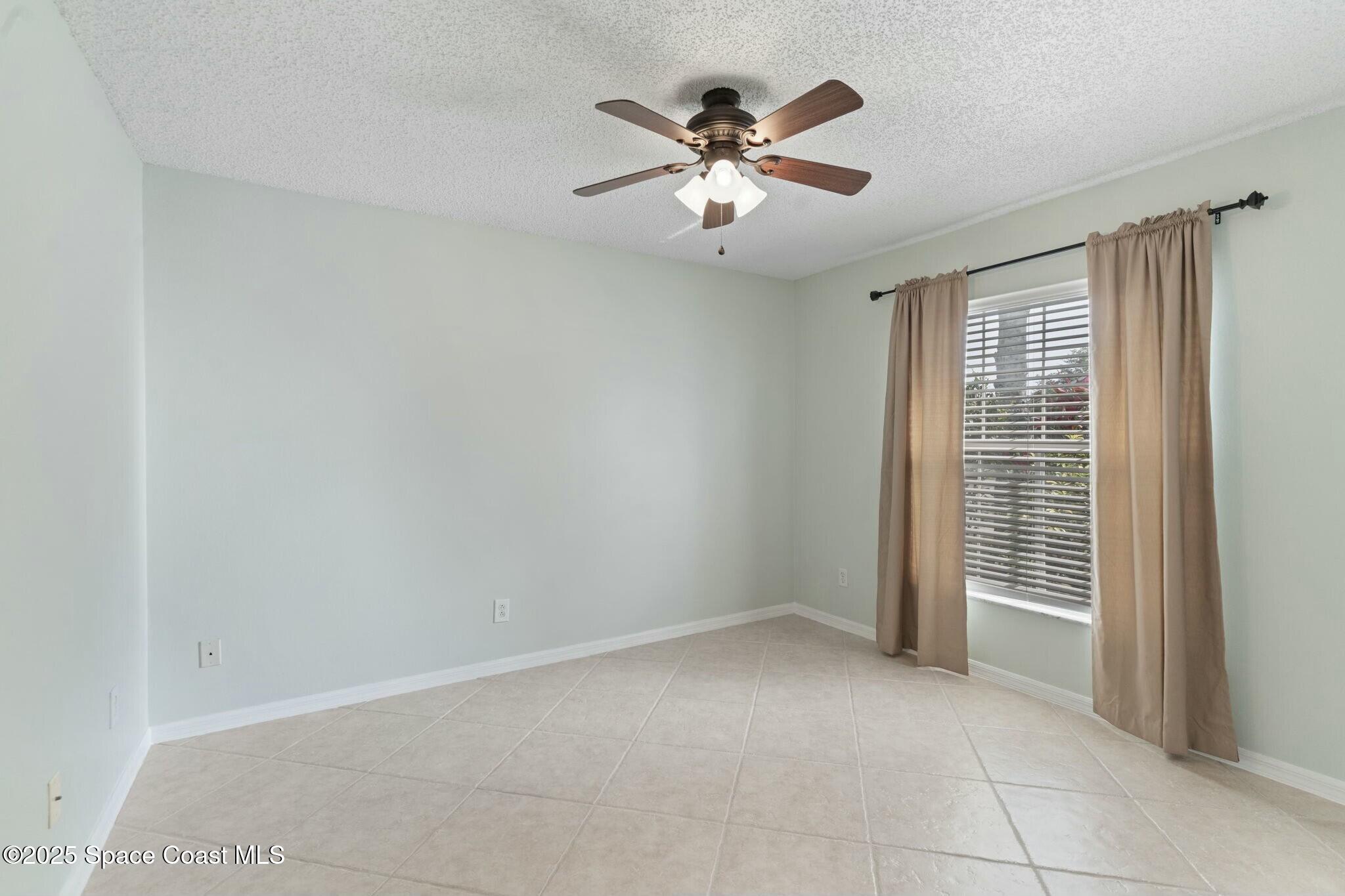 2405 Bayhill Drive Melbourne, FL 32940 - Photo 20 of 36 a view of an empty room with a window