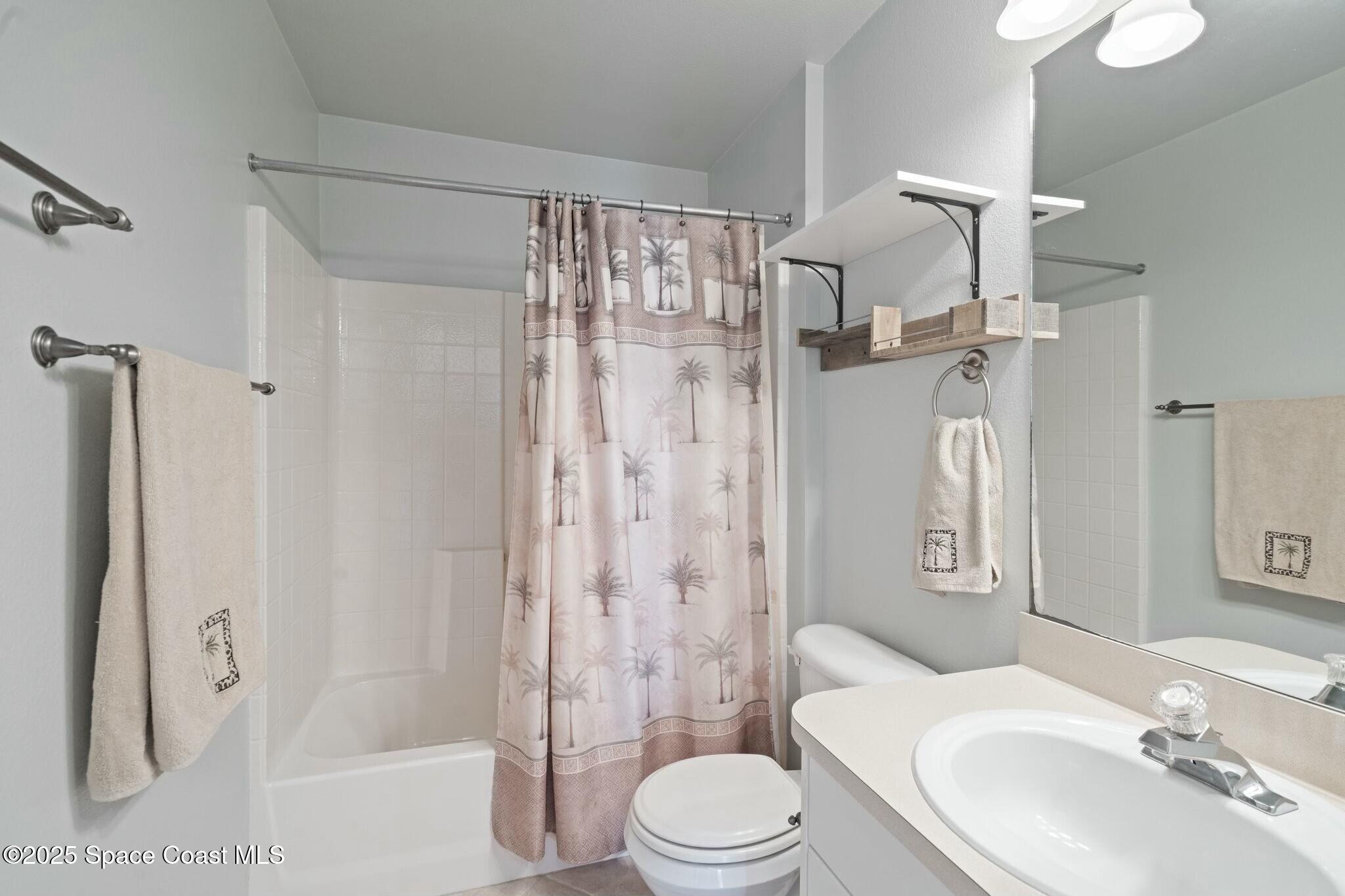 2405 Bayhill Drive Melbourne, FL 32940 - Photo 21 of 36 a bathroom with a toilet sink and shower