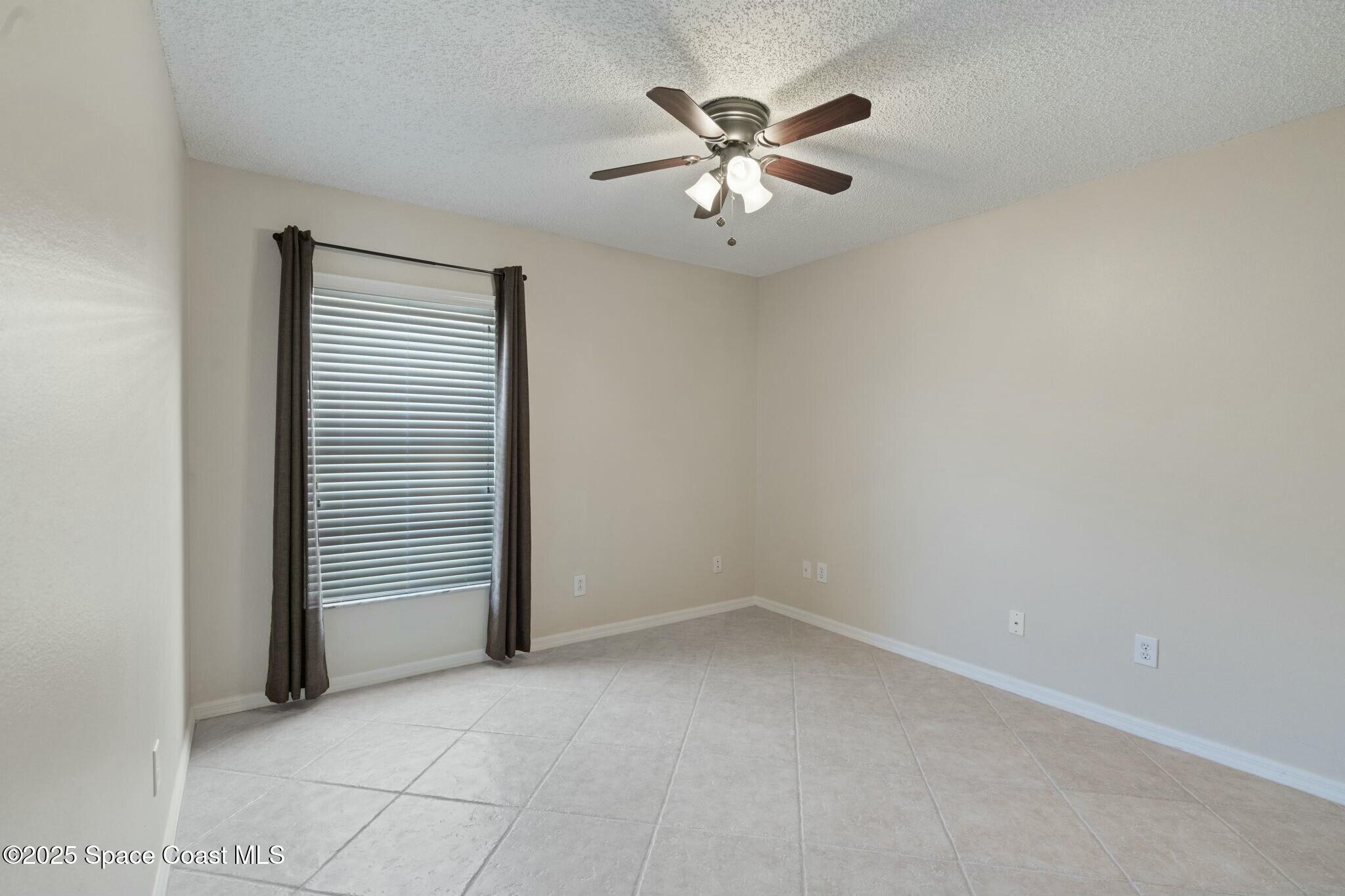 2405 Bayhill Drive Melbourne, FL 32940 - Photo 22 of 36 an empty room with windows