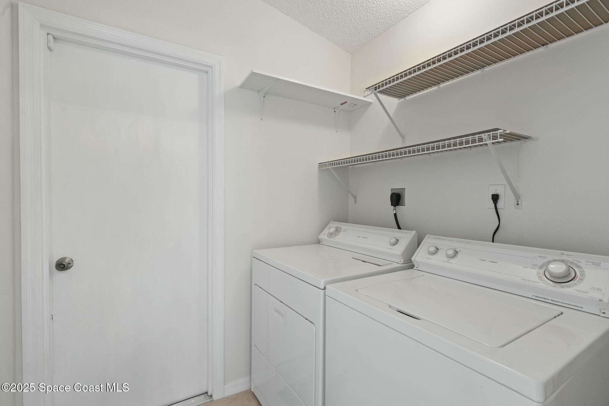 2405 Bayhill Drive Melbourne, FL 32940 - Photo 26 of 36 a utility room with dryer and washer