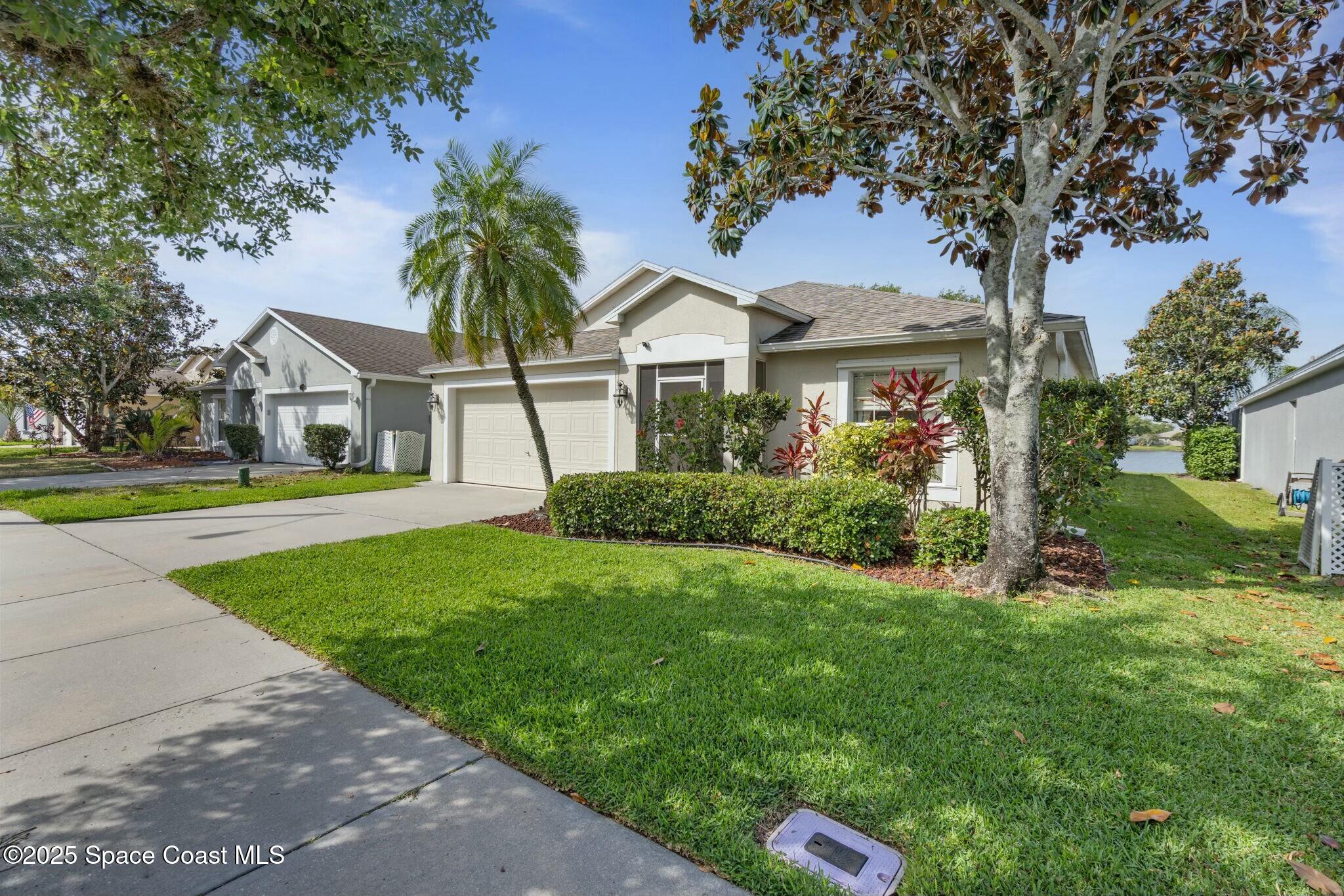 2405 Bayhill Drive Melbourne, FL 32940 - Photo 31 of 36 a front view of a house with a yard