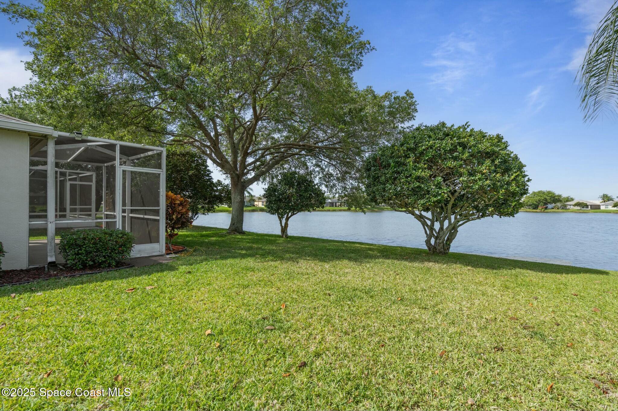 2405 Bayhill Drive Melbourne, FL 32940 - Photo 4 of 36 a view of a backyard with a garden and trees