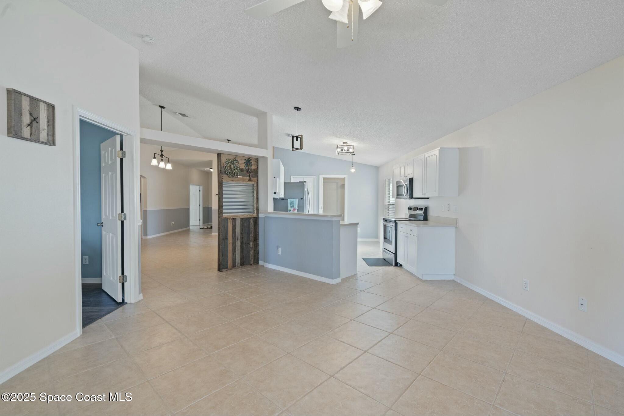 2405 Bayhill Drive Melbourne, FL 32940 - Photo 7 of 36 a view of a kitchen with refrigerator and a sink