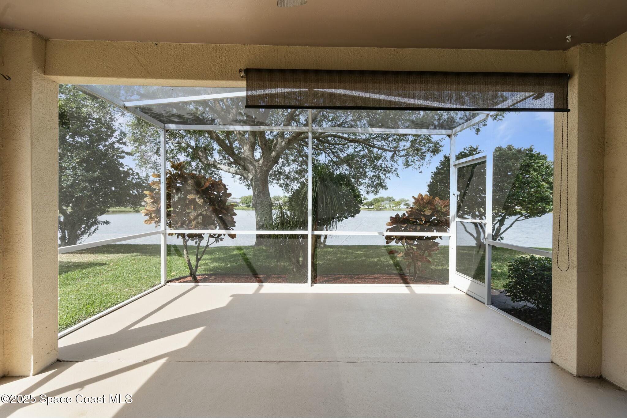 2405 Bayhill Drive Melbourne, FL 32940 - Photo 10 of 36 a view of porch with a flat tv screen and a floor to ceiling window