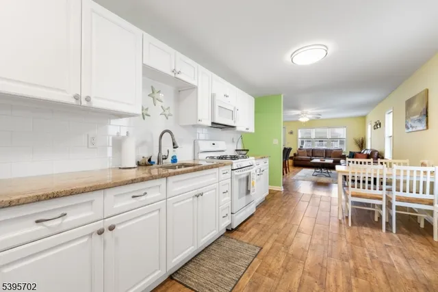 a large white kitchen with cabinets