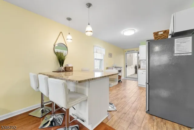 a view of a kitchen area with furniture and wooden floor