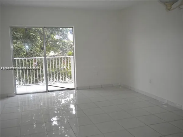 a view of empty room with floor to ceiling window