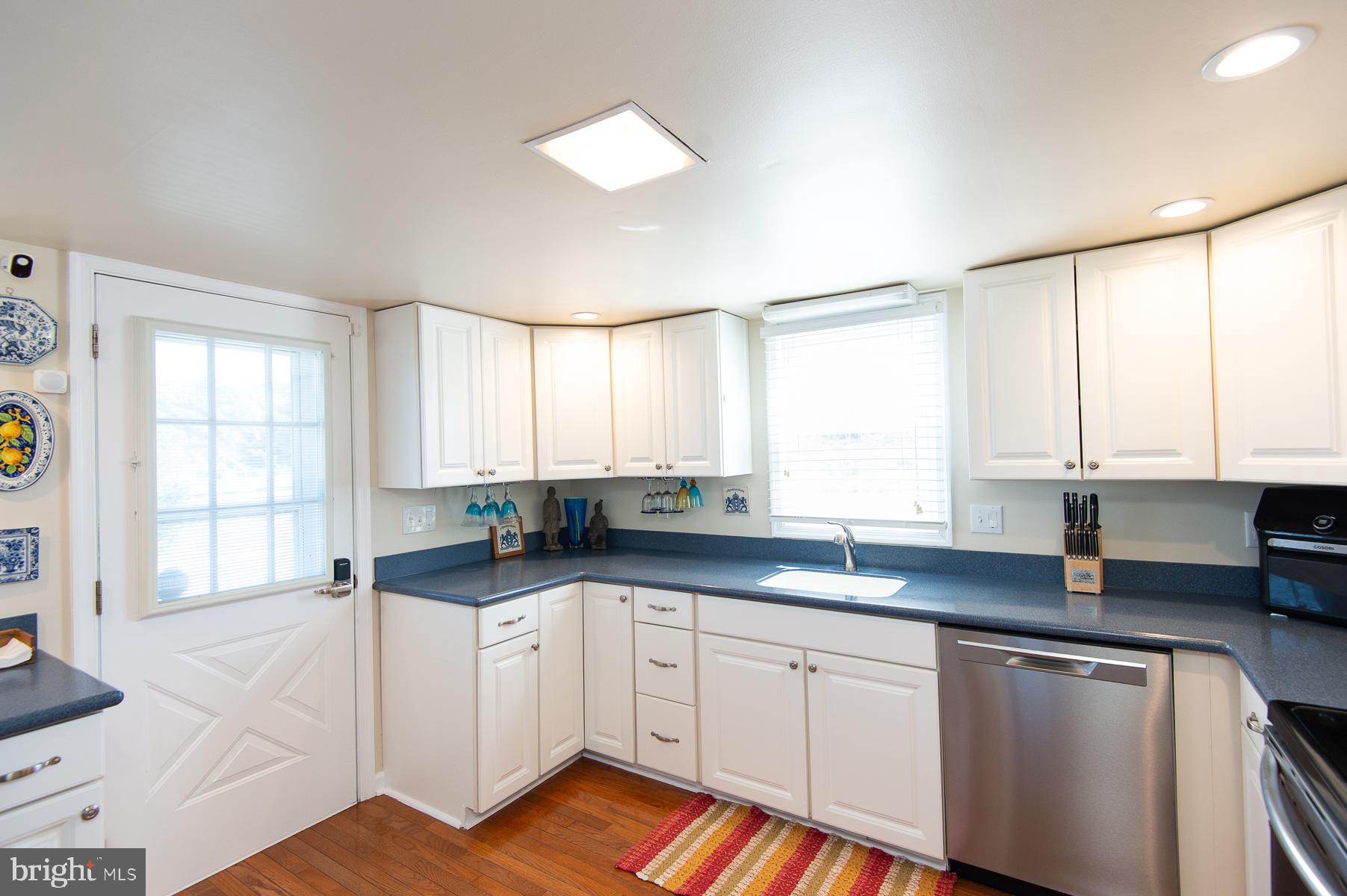 5558 Bowen Road Cambridge, MD 21613 - Photo 7 of 33 a kitchen with a sink a window and cabinets