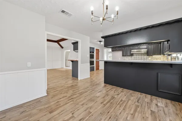 a spacious bathroom with double vanity and mirrors