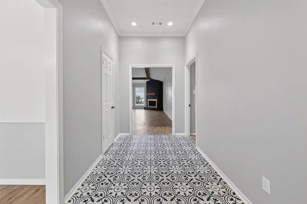 a view of empty room with wooden floor and fireplace
