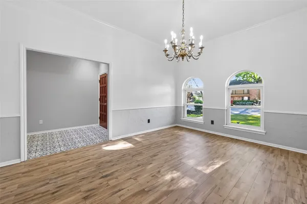 a kitchen with stainless steel appliances kitchen island granite countertop a sink counter space cabinets and a large window