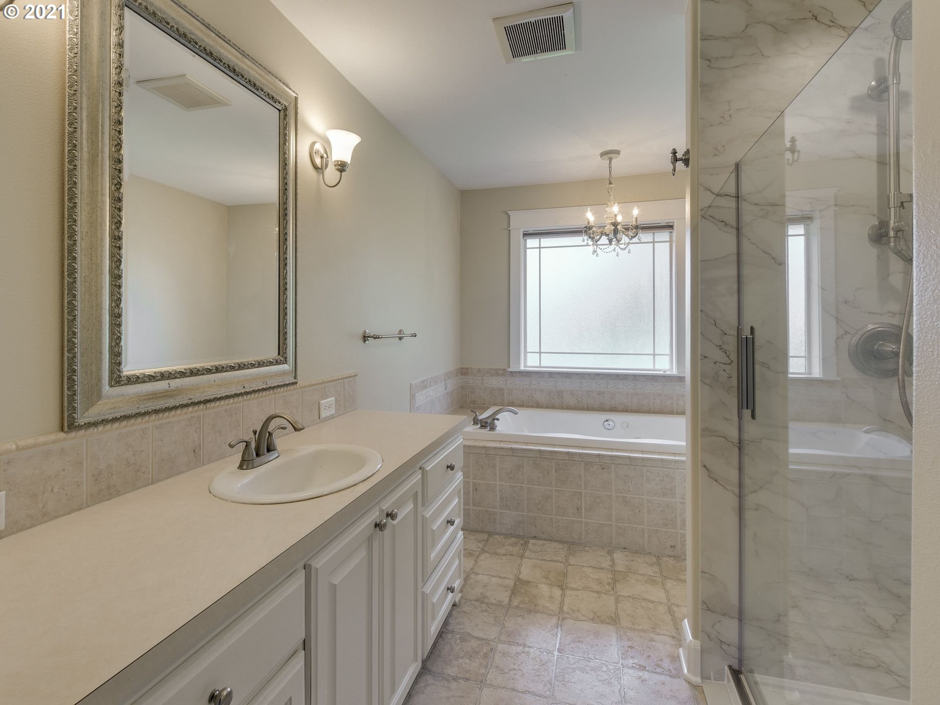 5171 South Elliott Prairie Road Woodburn, OR 97071 - Photo 12 of 32 a bathroom with a tub sink and mirror