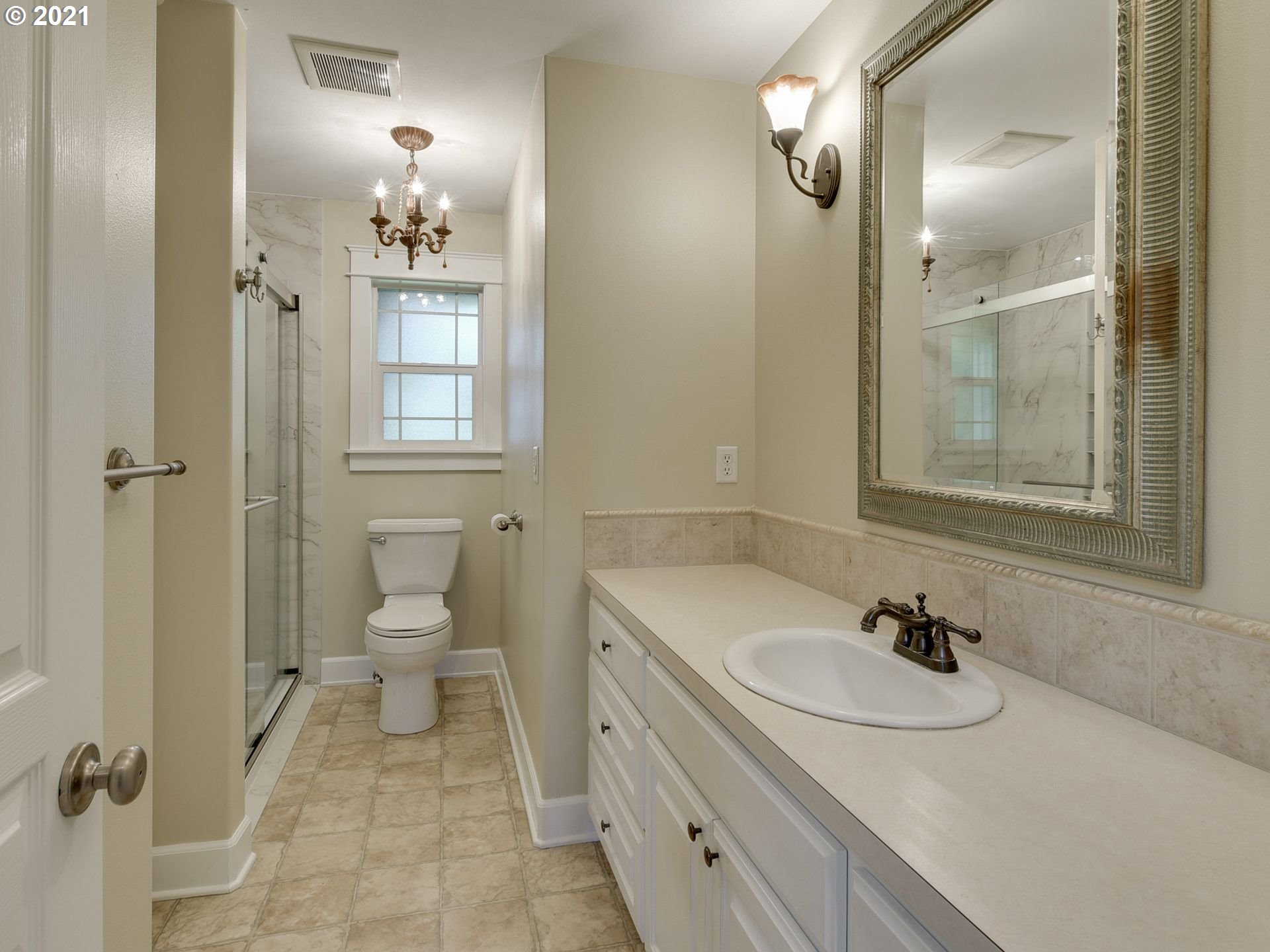 5171 South Elliott Prairie Road Woodburn, OR 97071 - Photo 16 of 32 a bathroom with a sink toilet a mirror and shower