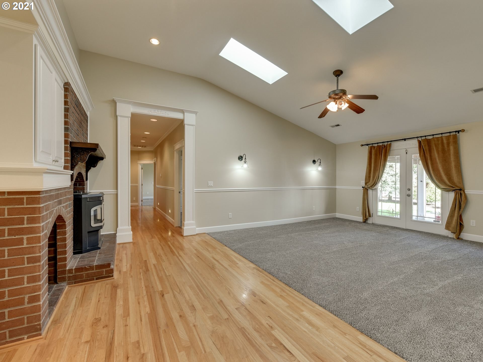 5171 South Elliott Prairie Road Woodburn, OR 97071 - Photo 9 of 32 a view of empty room with wooden floor and fan